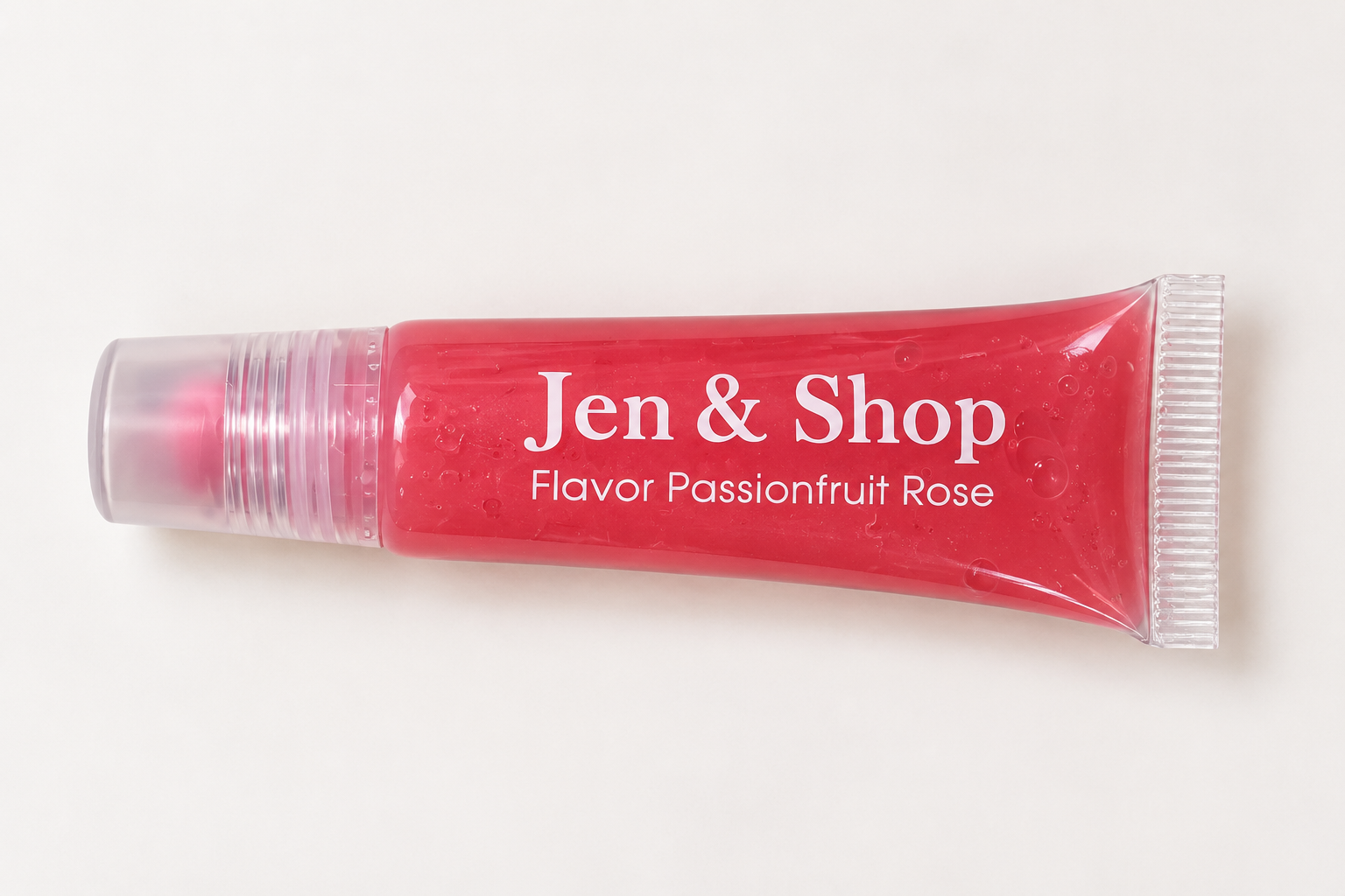 Jen & Shop Passionfruit Rose pink lip gloss in a clear tube